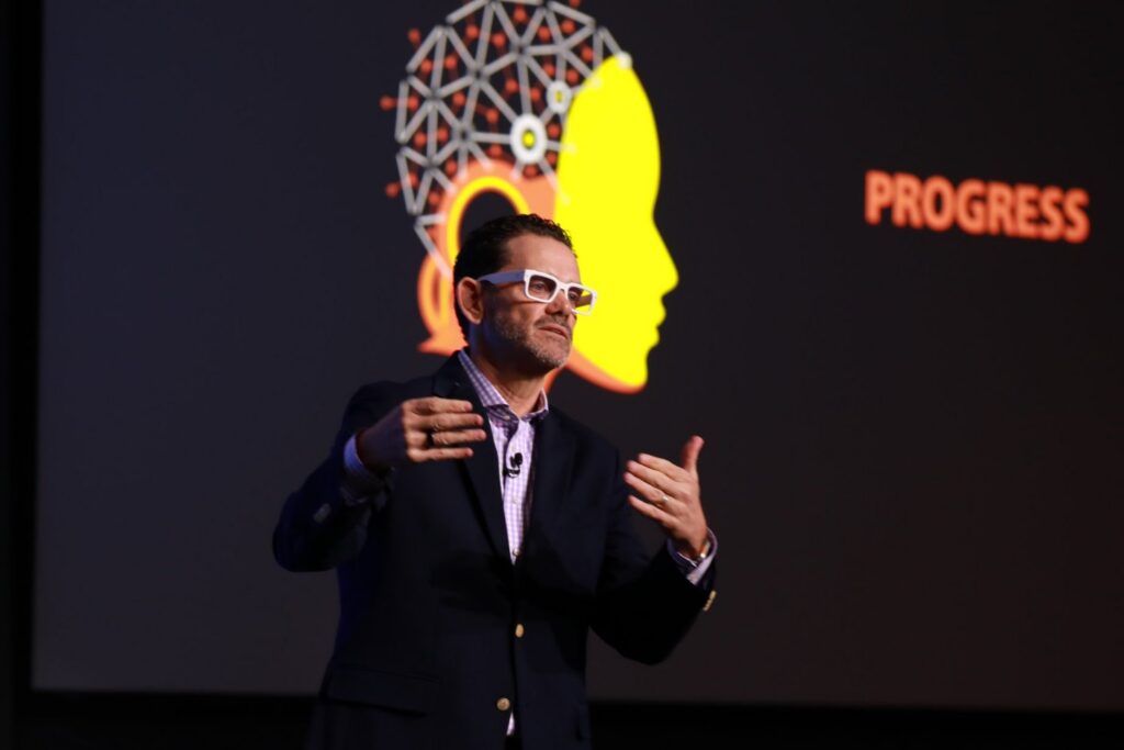 Chris Dyer on stage delivering his AI keynote, Beyond the Prompt